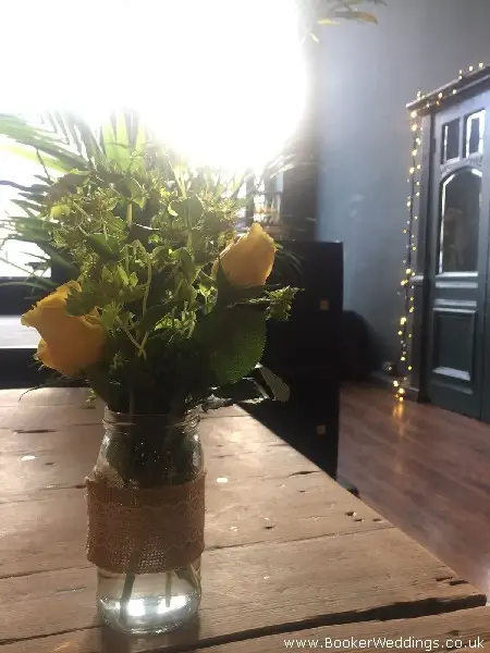 wedding table centres hessian jamjars with yellow roses and burpurleum