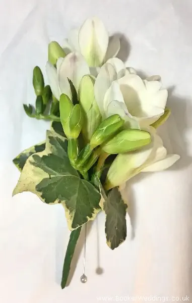 White freesia pin corsage for mother of the bride or groom