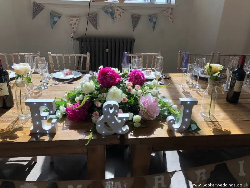 Top Table Arrangement of Roses and Peonies at Oh Me Oh My Wedding Venue