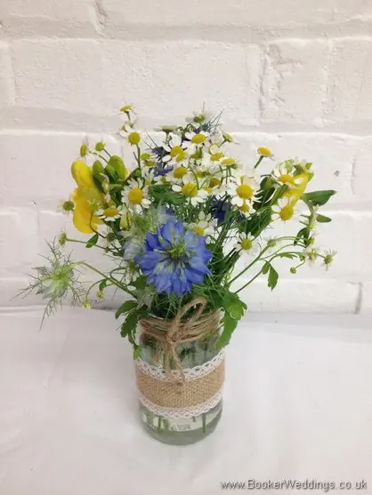 Table centrepieces in a just picked wild country style with freesia, nigela, Tanacetum.jpg
