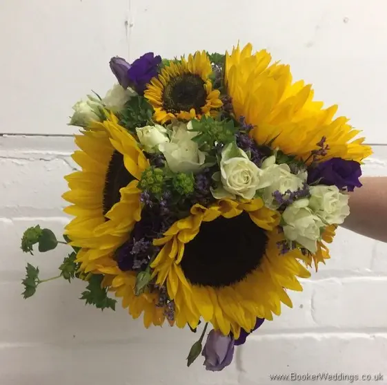 Bridesmaid handtied bouquet with sunflowers, yellow gerberas, white spray roses, purple limoneum and purple lissianthus