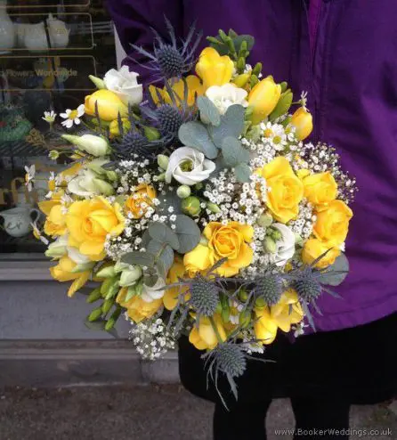 Handtied Yellow and blue bridal bouquet with eryngium, daisy, spray rose, lisianthus and freesias