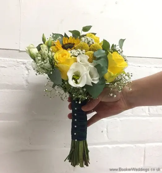 Bridal handtied bouquet in yellow and creams with yellow sunflowers, craspedia, roses, gypsy grass, lissanthus and grey eucalyptus side view