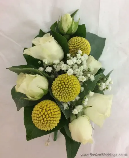 Yellow and white pin corsage with spray roses, craspedia and gypsophila