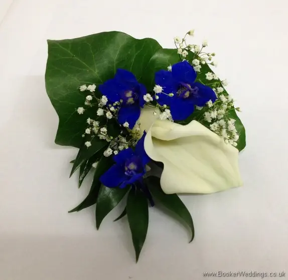 Blue and White Grooms Buttonhole featuring white calla lilies, blue delphinium and gypsy Grass top view